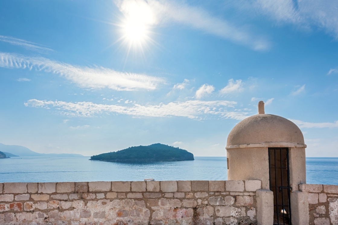 'Gun turret on old city walls of Dubrovnik city (Croatia) with island Lokrum in background.' - Dubrovnik